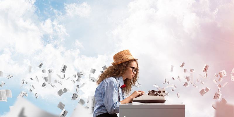 Young girl typing while pages are flying in the background